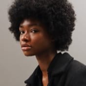 A close up shot of a stylish black afro girl in black shirt 